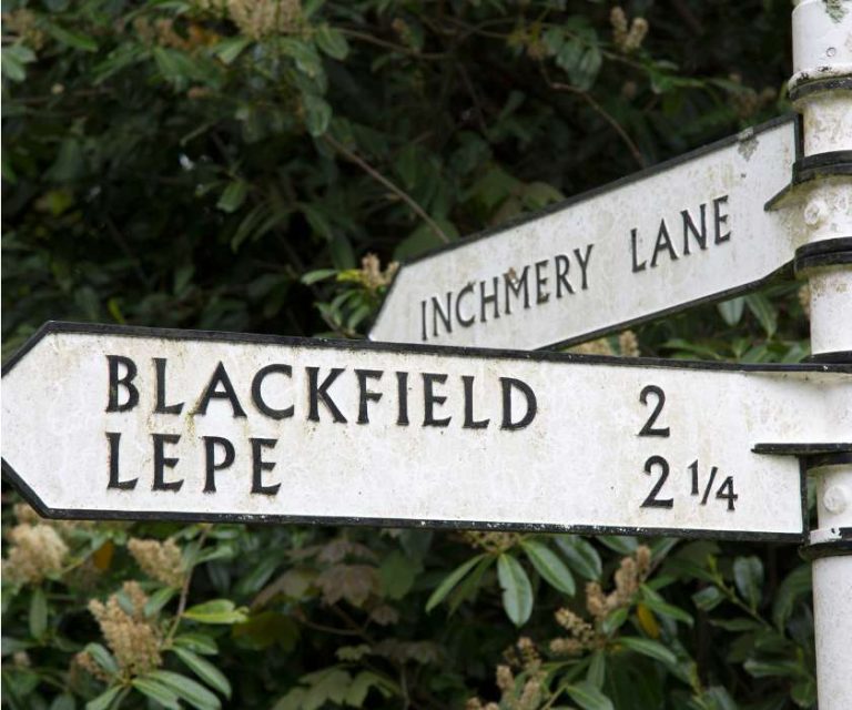 Traditional directional sign in Blackfield pointing towards local landmarks.